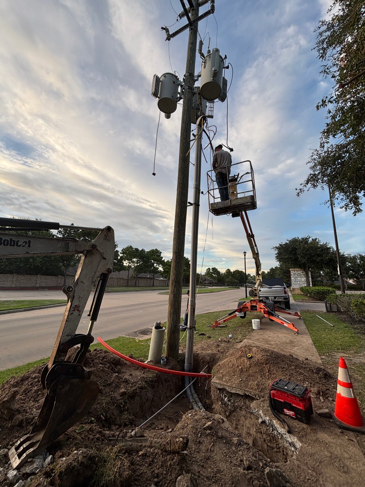 VCG Electrical technician working on a power pole from a bucket lift in Houston