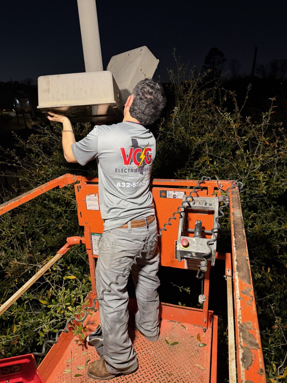 VCG Electrical technician working from a bucket lift on a Houston job