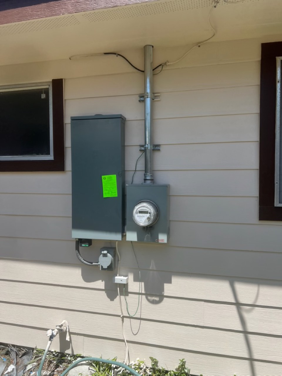 New electrical service panel and meter base installed on a Houston home